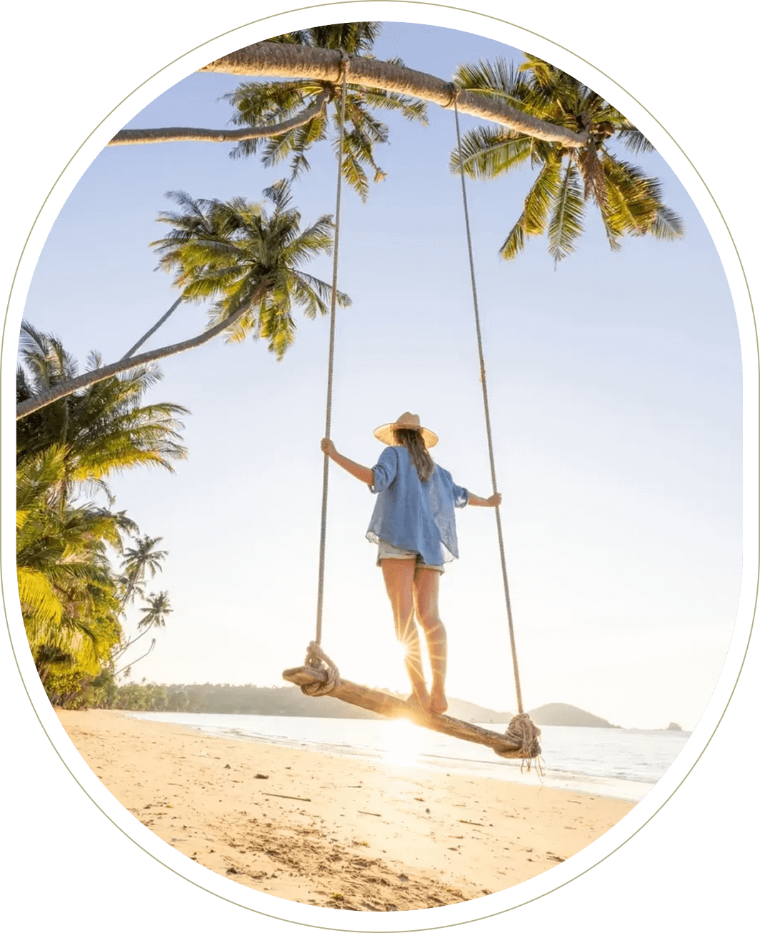Woman on beach swing under palm trees.